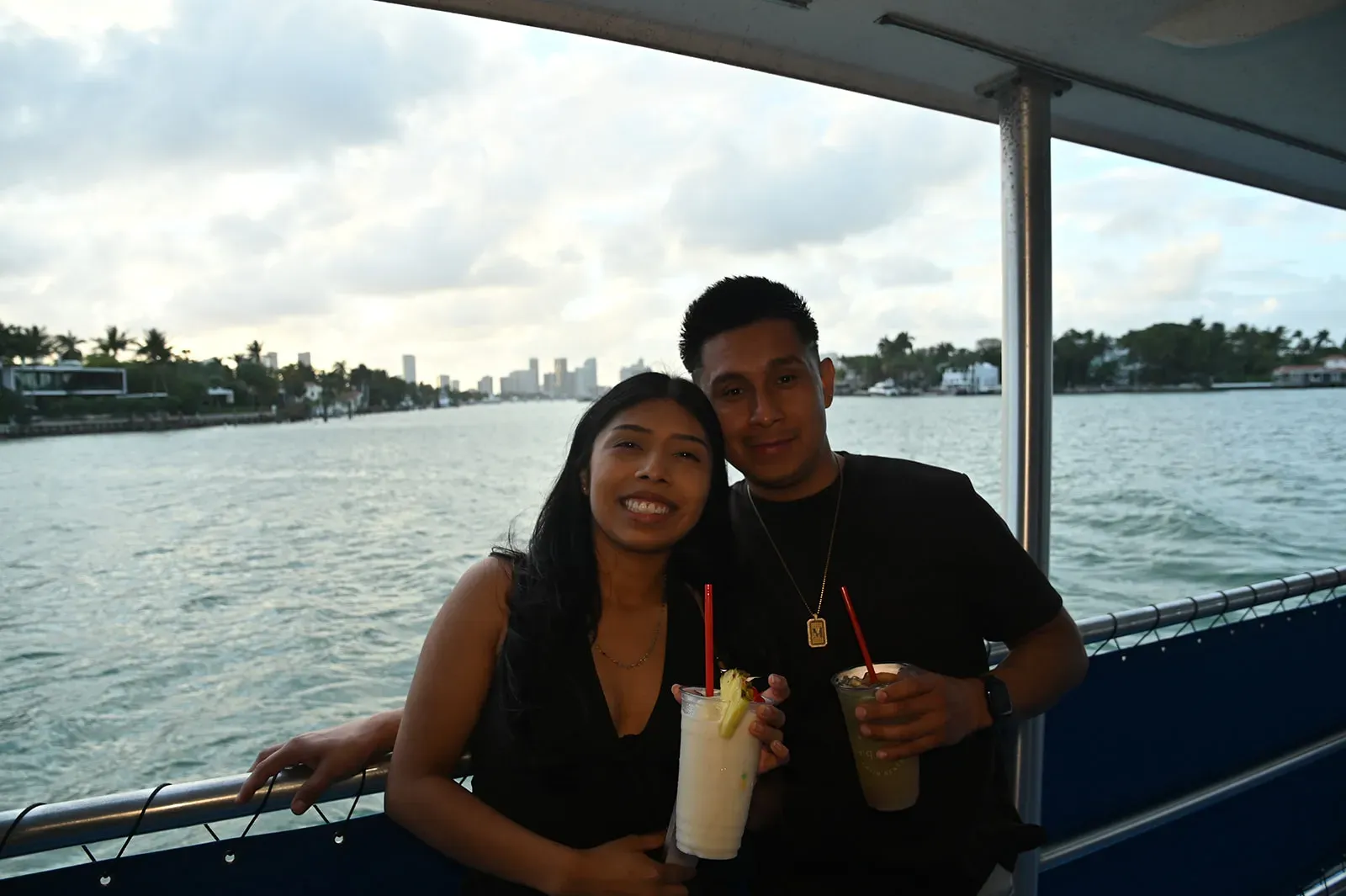 couple enjoying drinks on a Miami boat tour with mojito bar on Biscayne Bay during sightseeing cruise