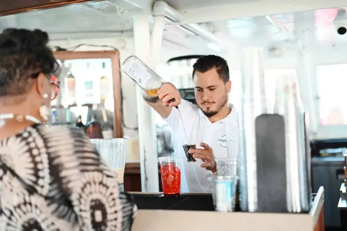 Bartender preparing drinks at the Mojito Bar onboard the Miami Boat Tour.