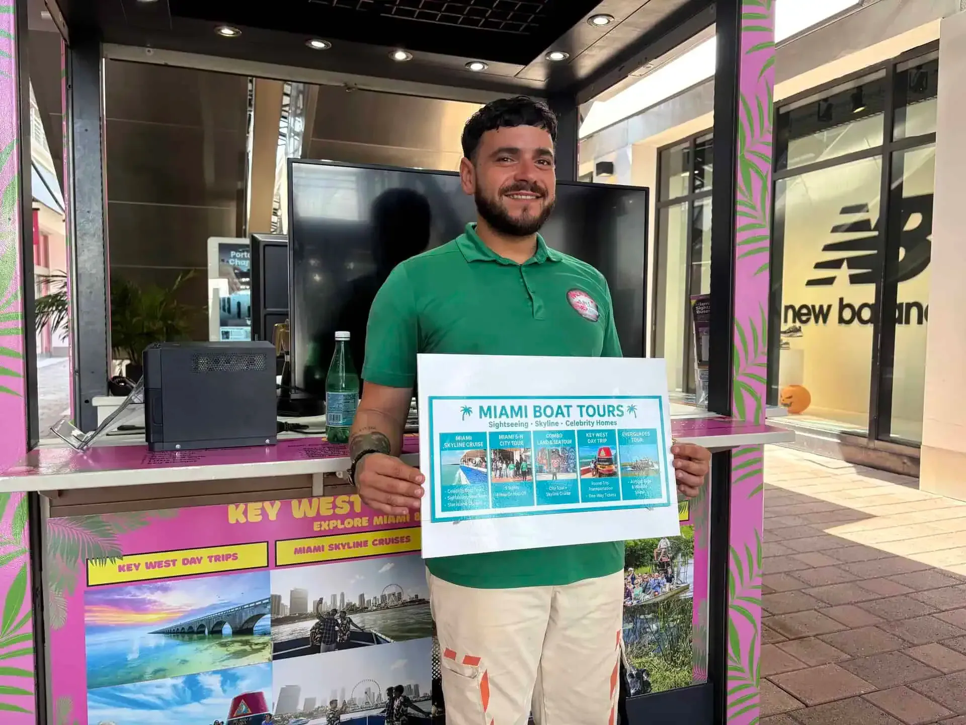 Miami Boat Tours staff member at the Bayside Marketplace kiosk helping guests with tour information and check-in.
