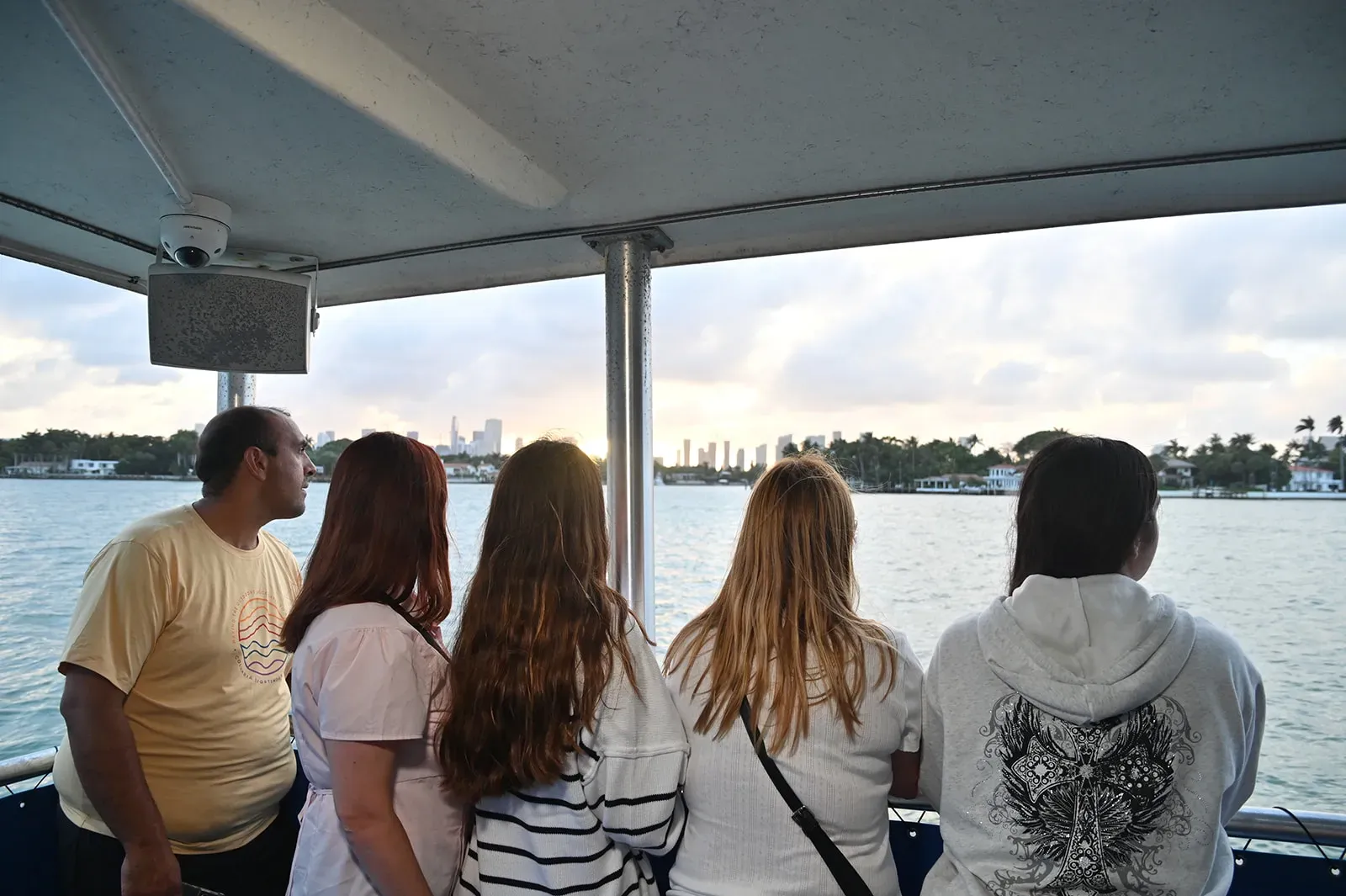 guests enjoying Miami Boat Tours during sunset with skyline views of Miami