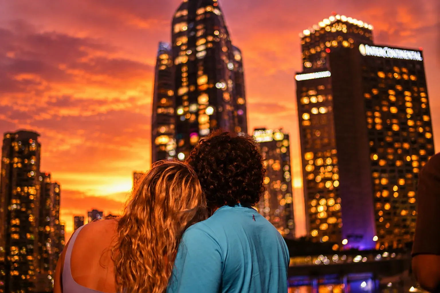 Couple enjoying a Miami Golden Hour sunset cruise with colorful skyline views and twilight reflections in Miami