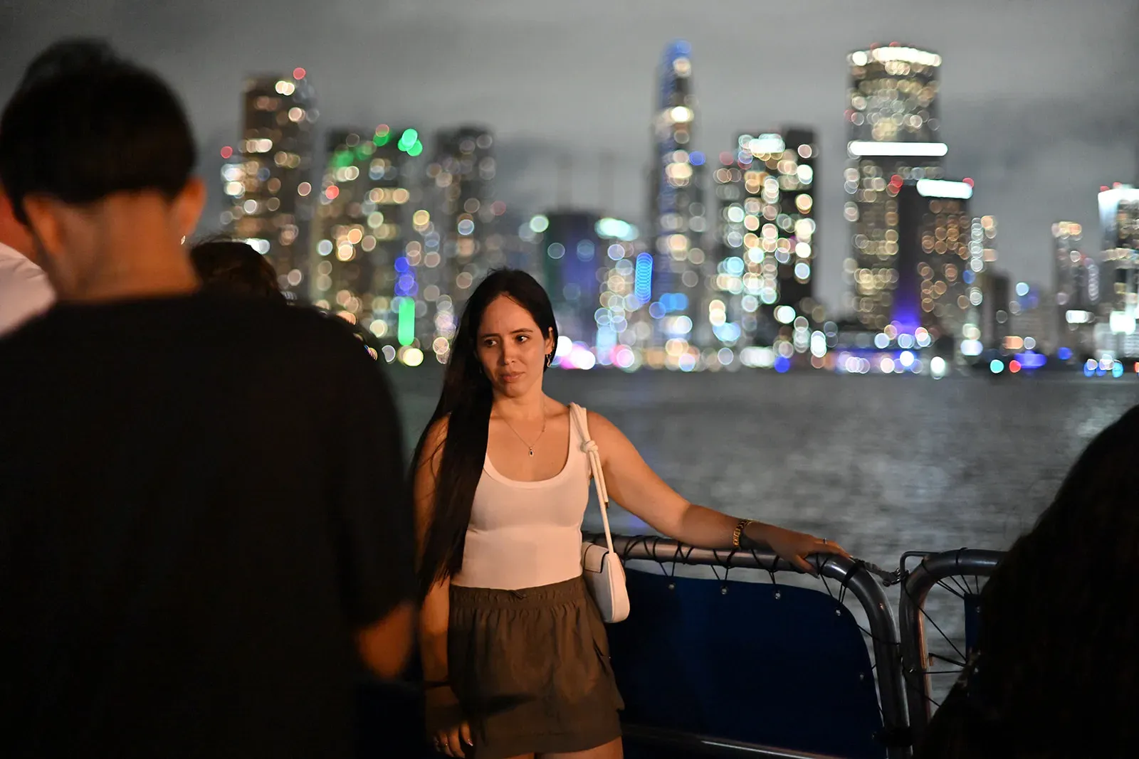 guest enjoying a Miami sightseeing cruise at night with skyline views on Biscayne Bay