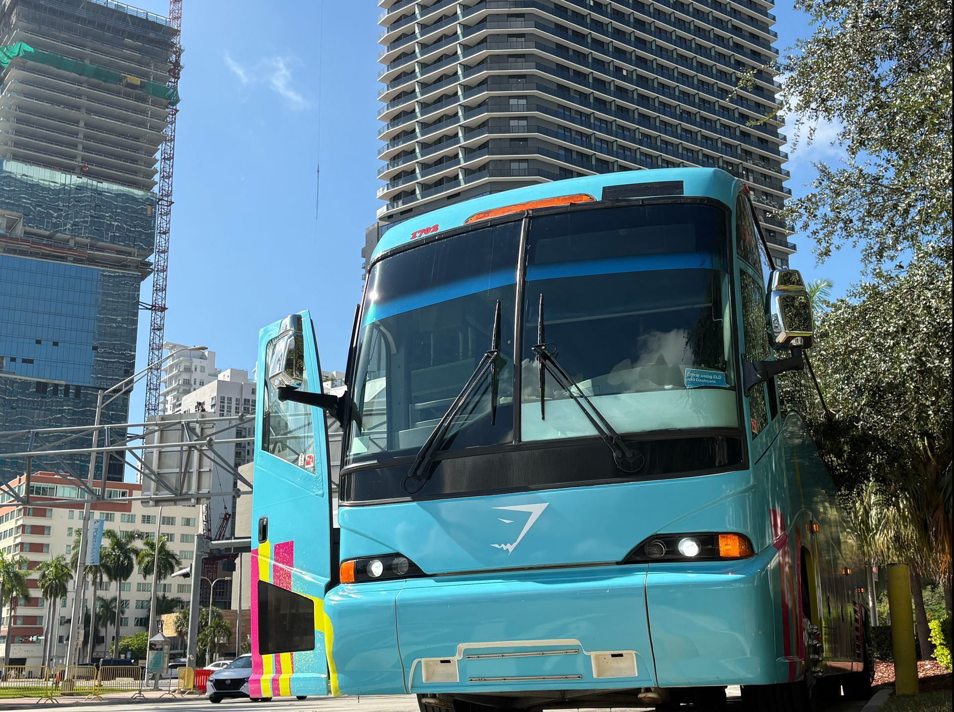 Miami to Key West bus tour pickup point with the turquoise tour bus ready for departure in Downtown Miami