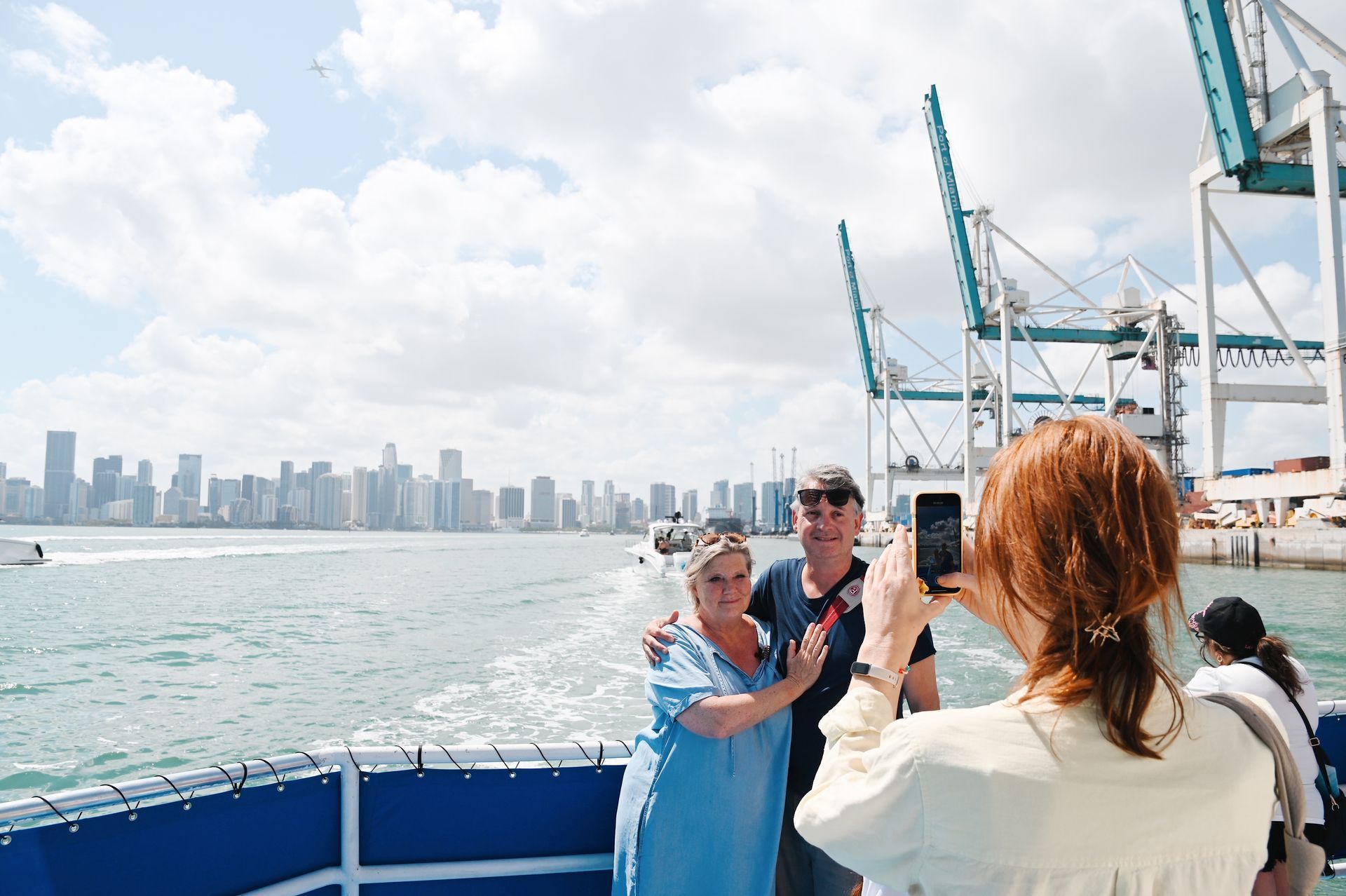Passengers taking a photo with the Miami Skyline in the background