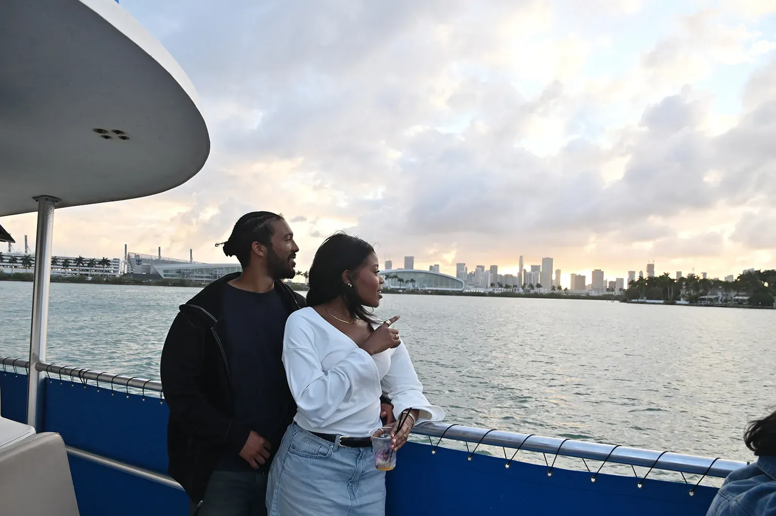 couple enjoying a romantic Boat tour Miami experience during sunset with skyline views