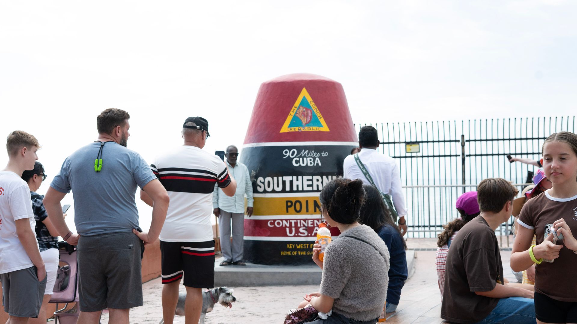 Tourists visiting the Southernmost Point Buoy in Key West, Florida