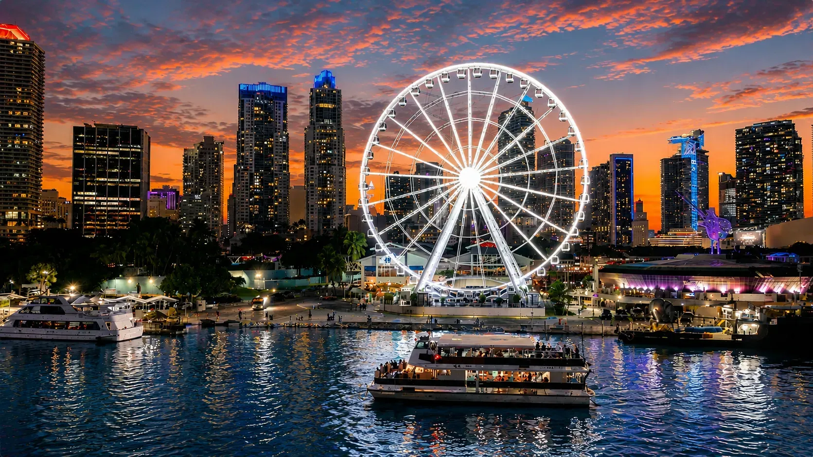 Sunset Mansion Boat Tour passing Bayside Marketplace with glowing Ferris wheel and Miami skyline at sunset