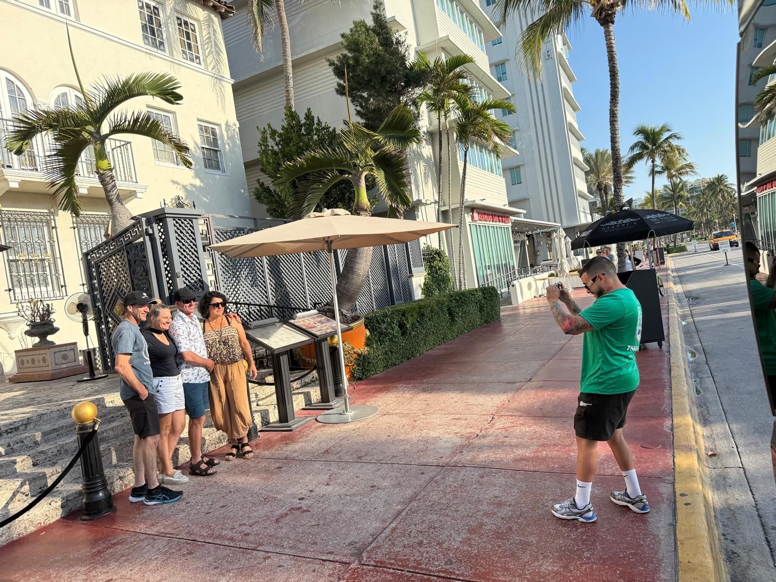 Tour Guide in South Beach with passengers taking photos in Ocean drive