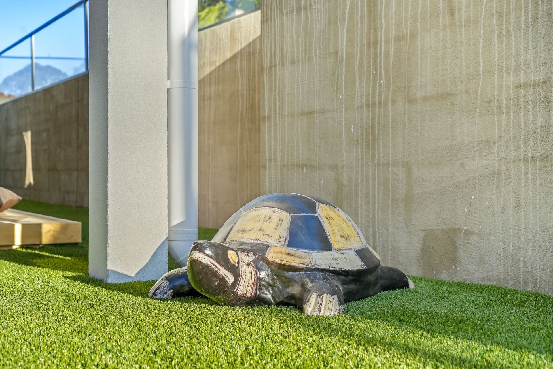 Decorative turtle statue on artificial turf lawn 
