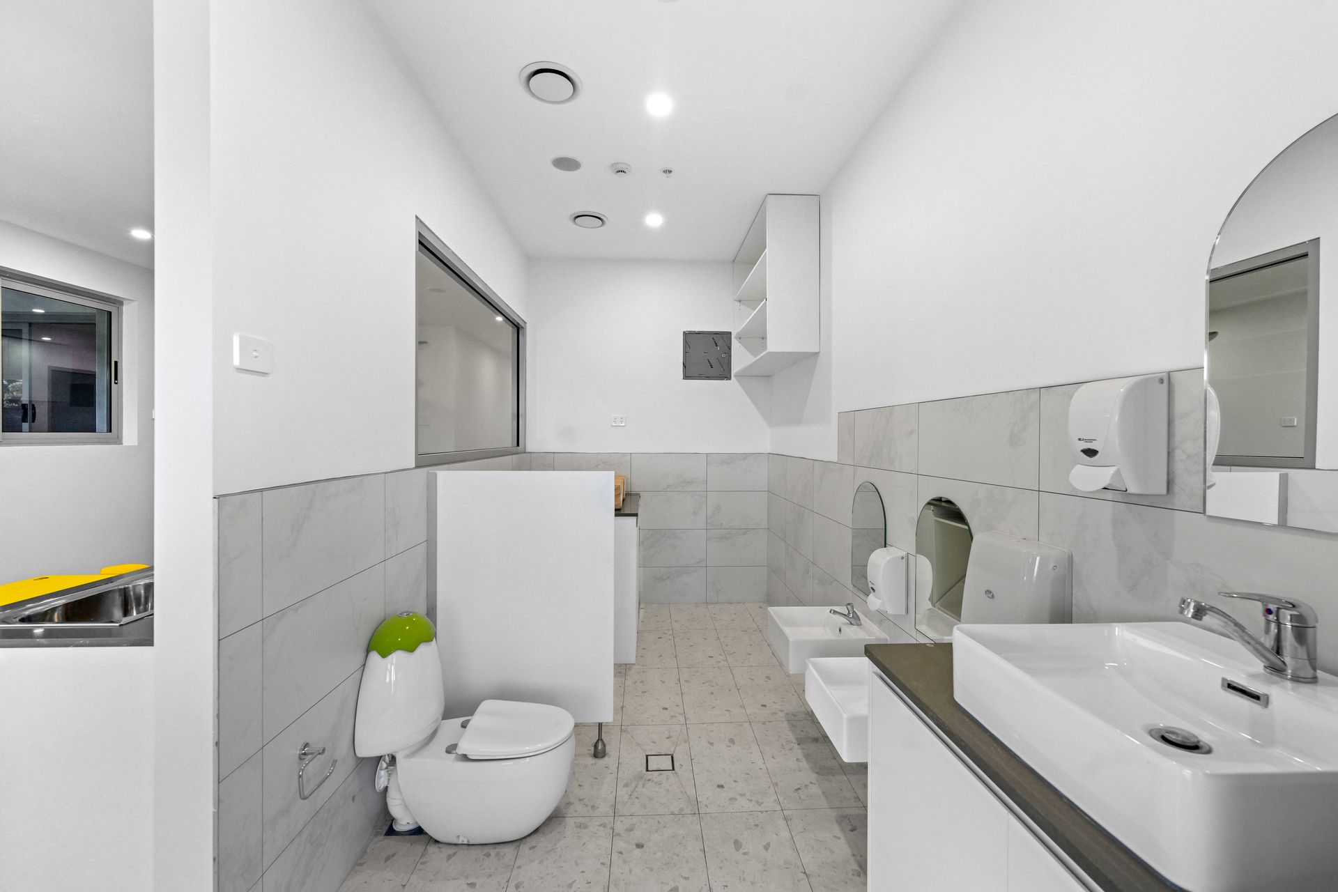 Children's toilet, sink, mirror, and dispensers. 