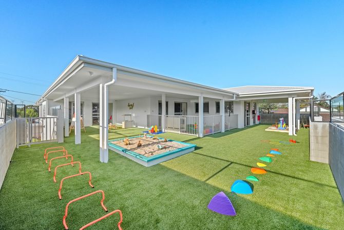 An artist 's impression of a family walking down a street in front of a house.