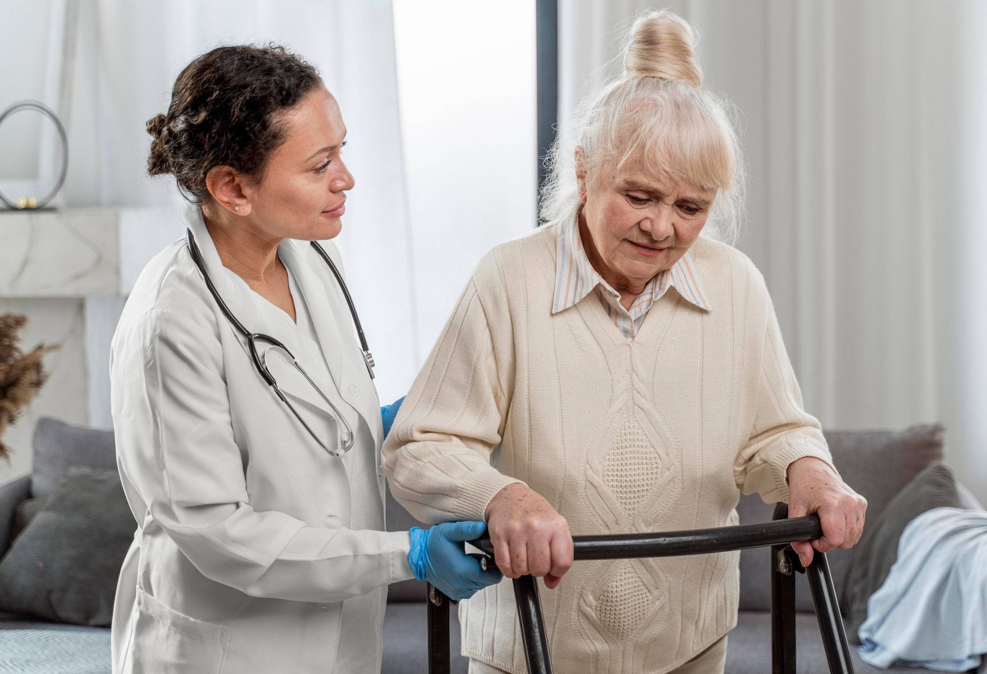 A health worker assists an elderly woman with a walker