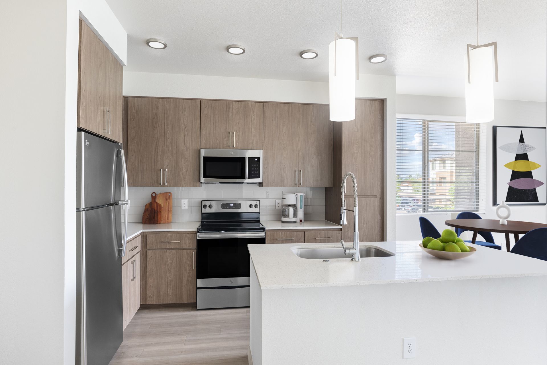 Modern kitchen with wood cabinets, stainless steel appliances, and a central island.