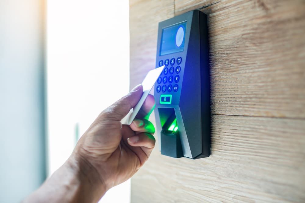 A Person is Using a Fingerprint Scanner to Open a Door — Coast & Hinterland Mobile Locksmiths In Noosaville, QLD
