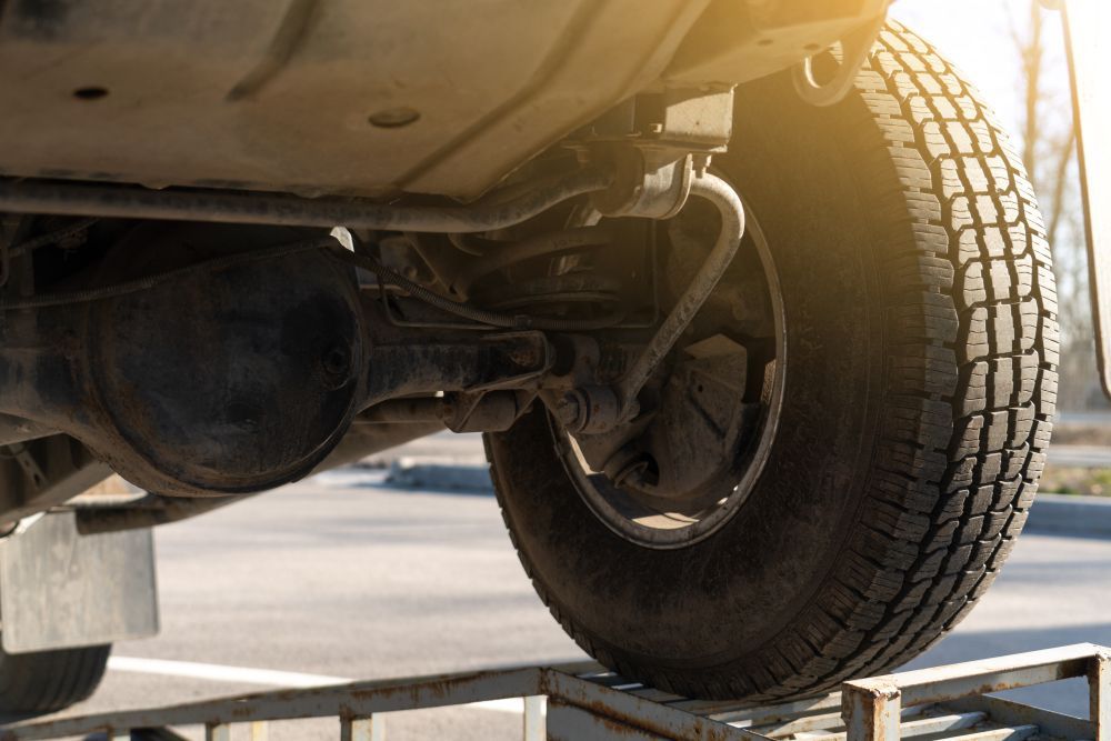 Underside of a Vehicle With a Tire on a Ramp — CE Automotive Service Centre in Garbutt, QLD