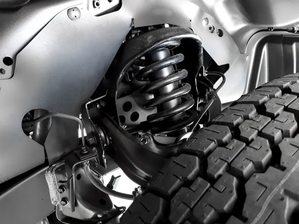 Close-up of a Vehicle's Suspension System Showing a Coil Spring — CE Automotive Service Centre in Garbutt, QLD