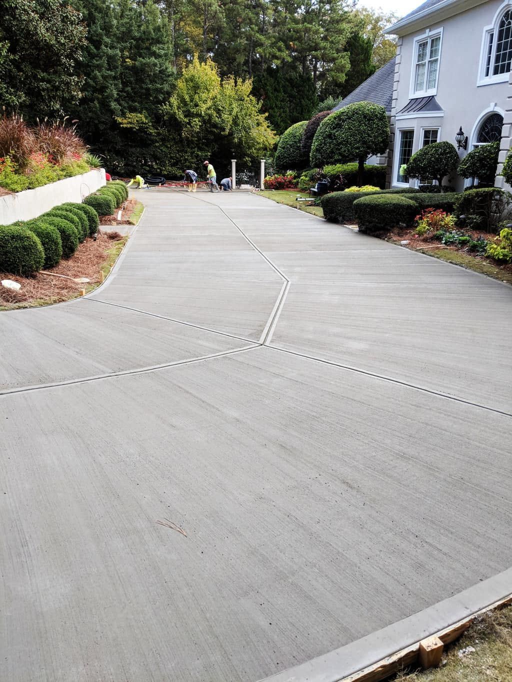 Concrete driveway leading to a house