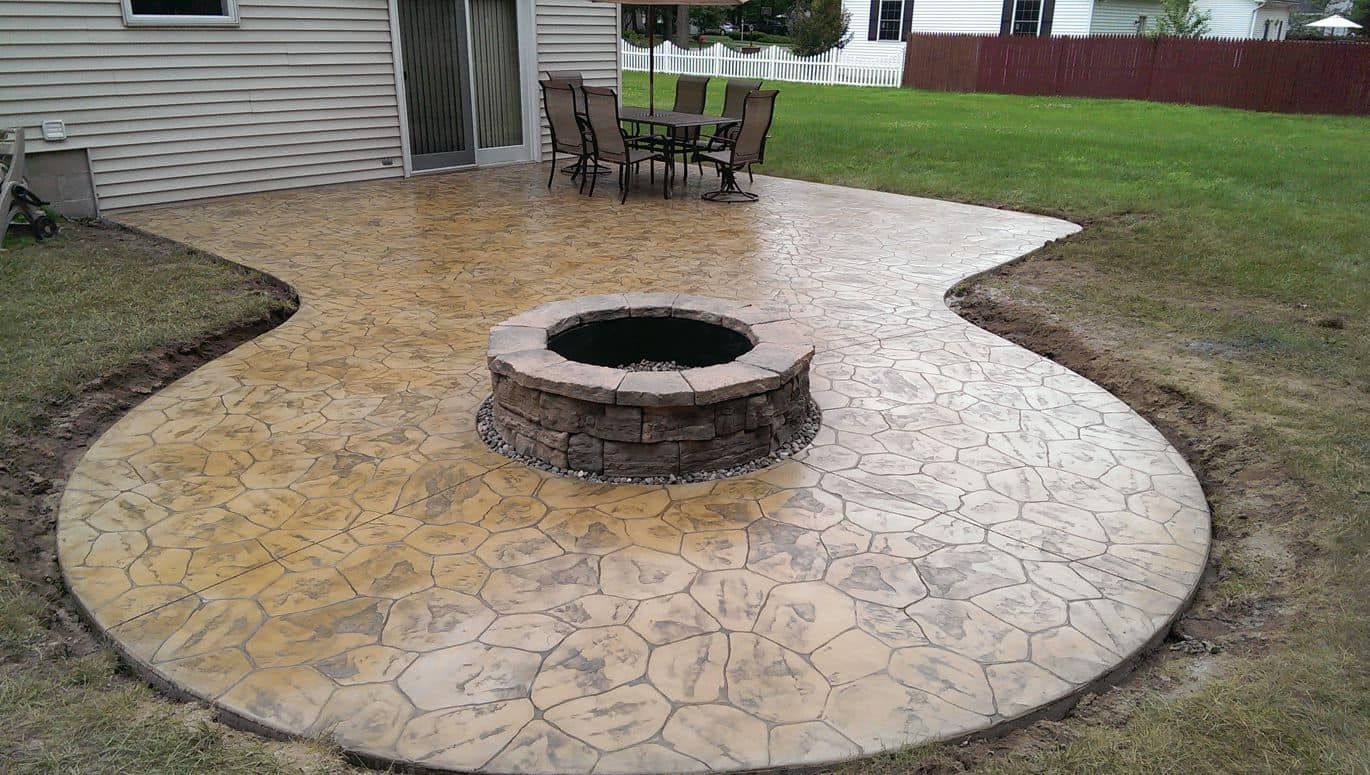 Concrete patio with fire pit and outdoor dining set