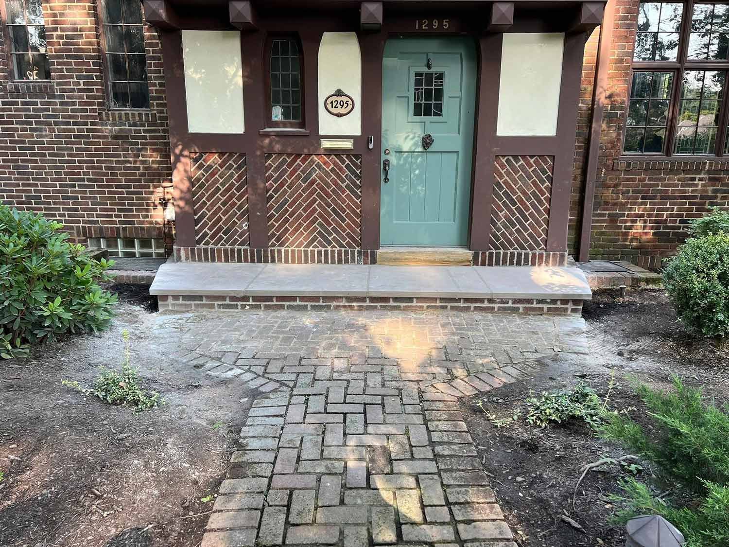 Brick pathway leads to a house