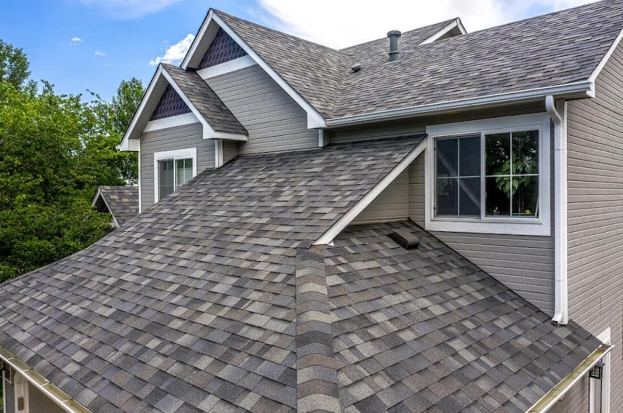 Asphalt shingle roof on a two-story house