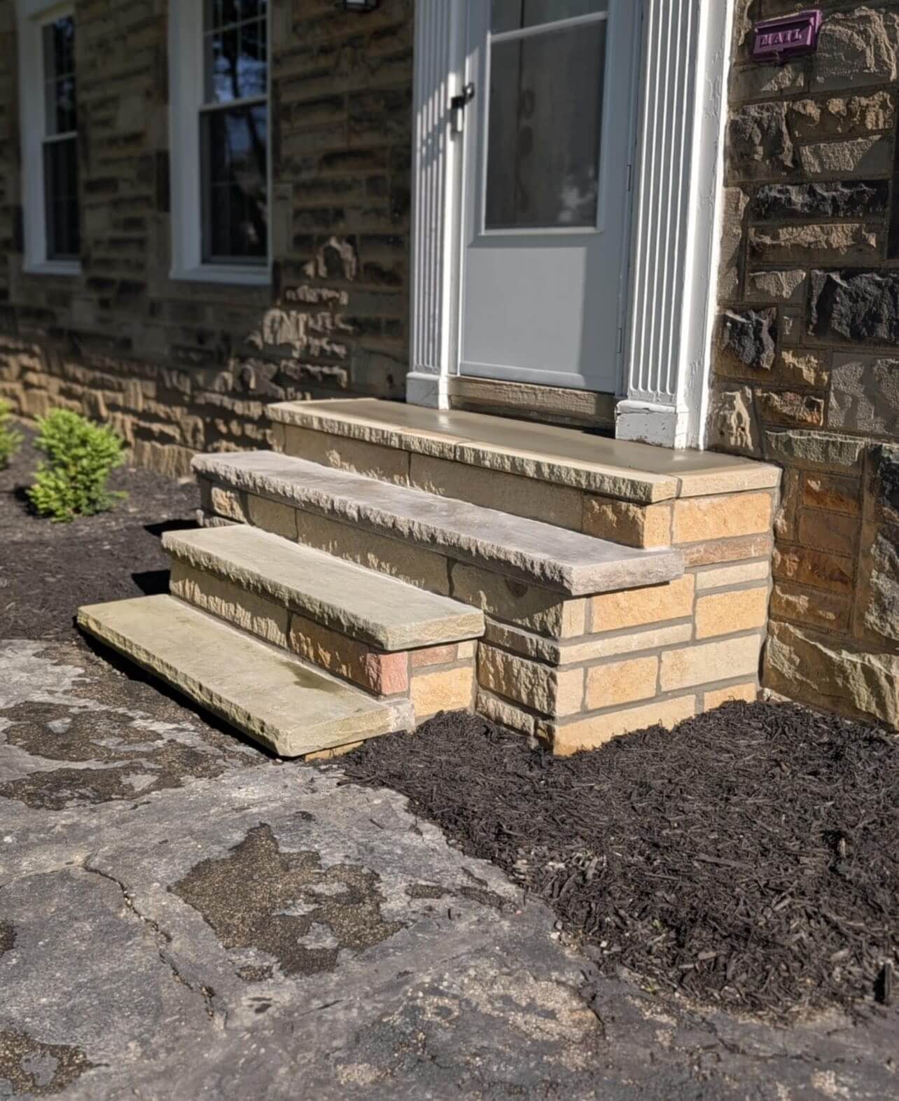 Stone steps leading to a white door