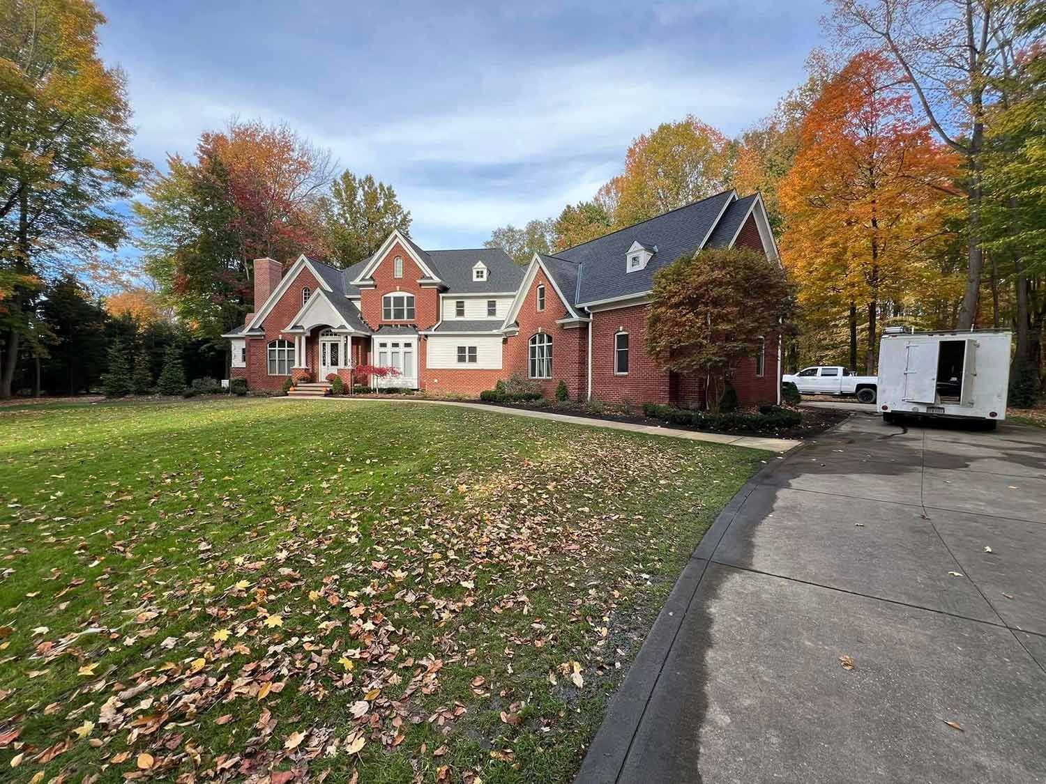 Red brick house with concrete driveway