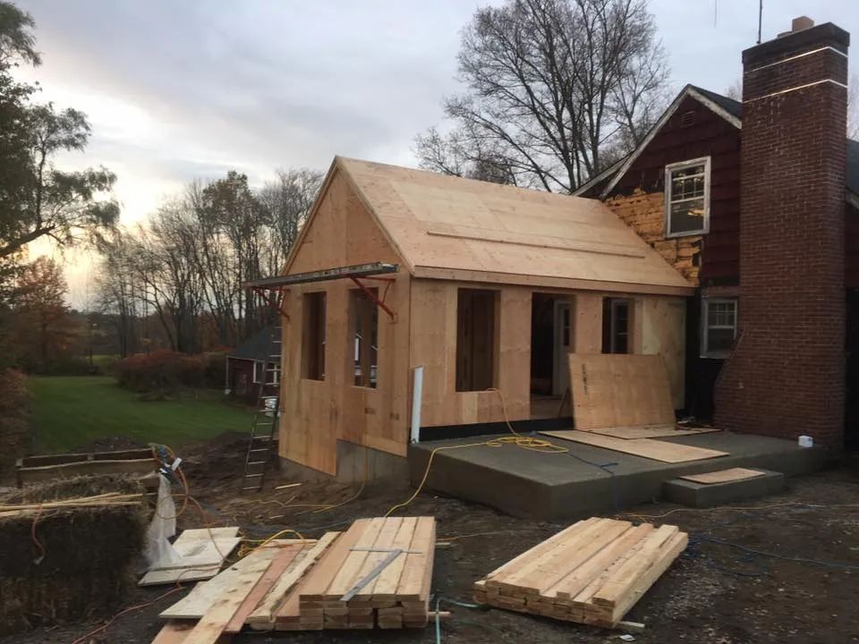 A house is being remodeled with a wooden roof