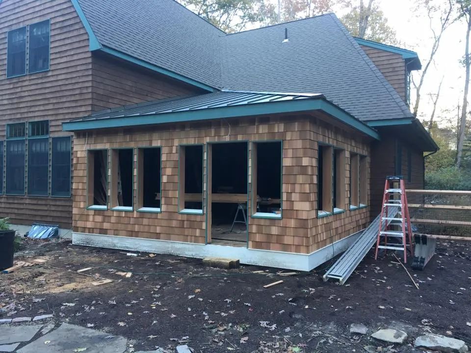 A large house with a ladder in front of it
