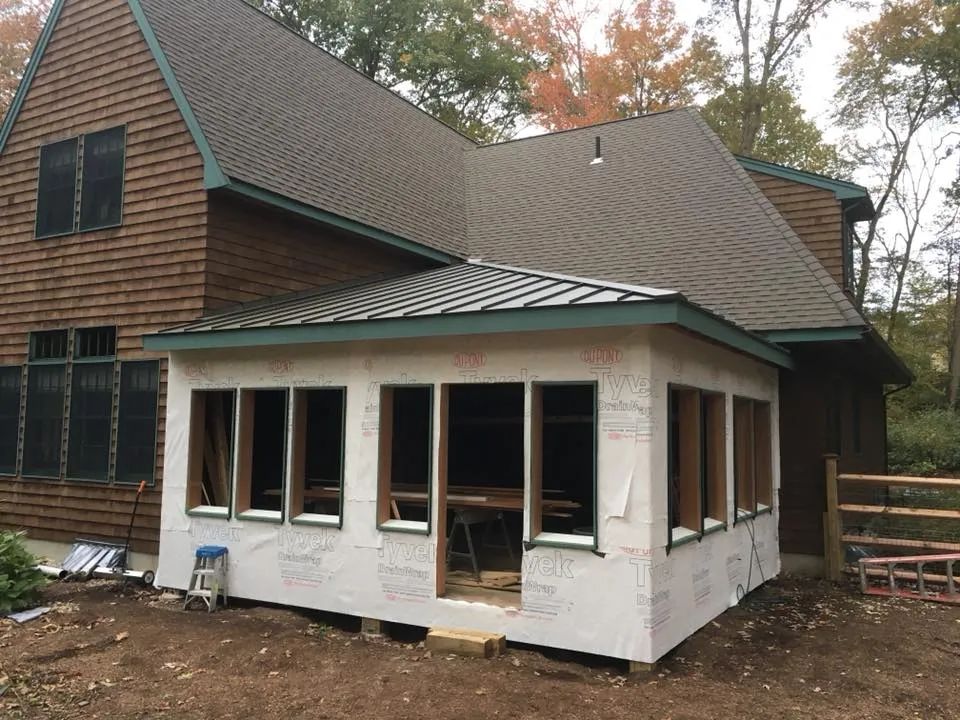 A house with a lot of windows is being remodeled