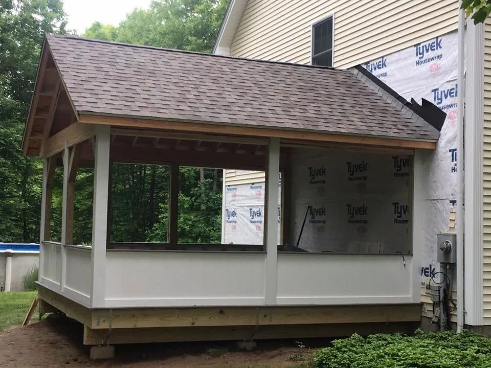 A gazebo is being built in the backyard of a house