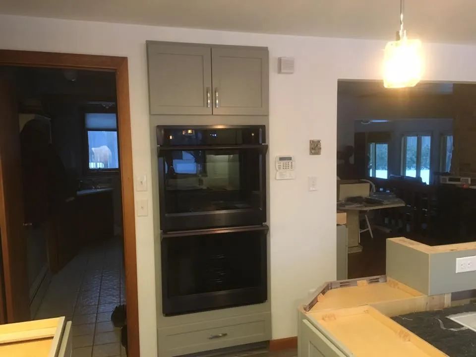 A kitchen with a double oven built into the wall