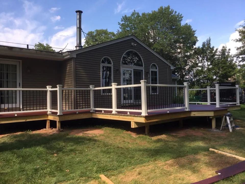 A house with a large deck in front of it.