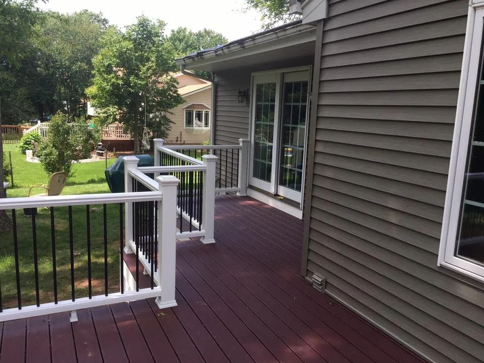 A house with a red deck and a white railing