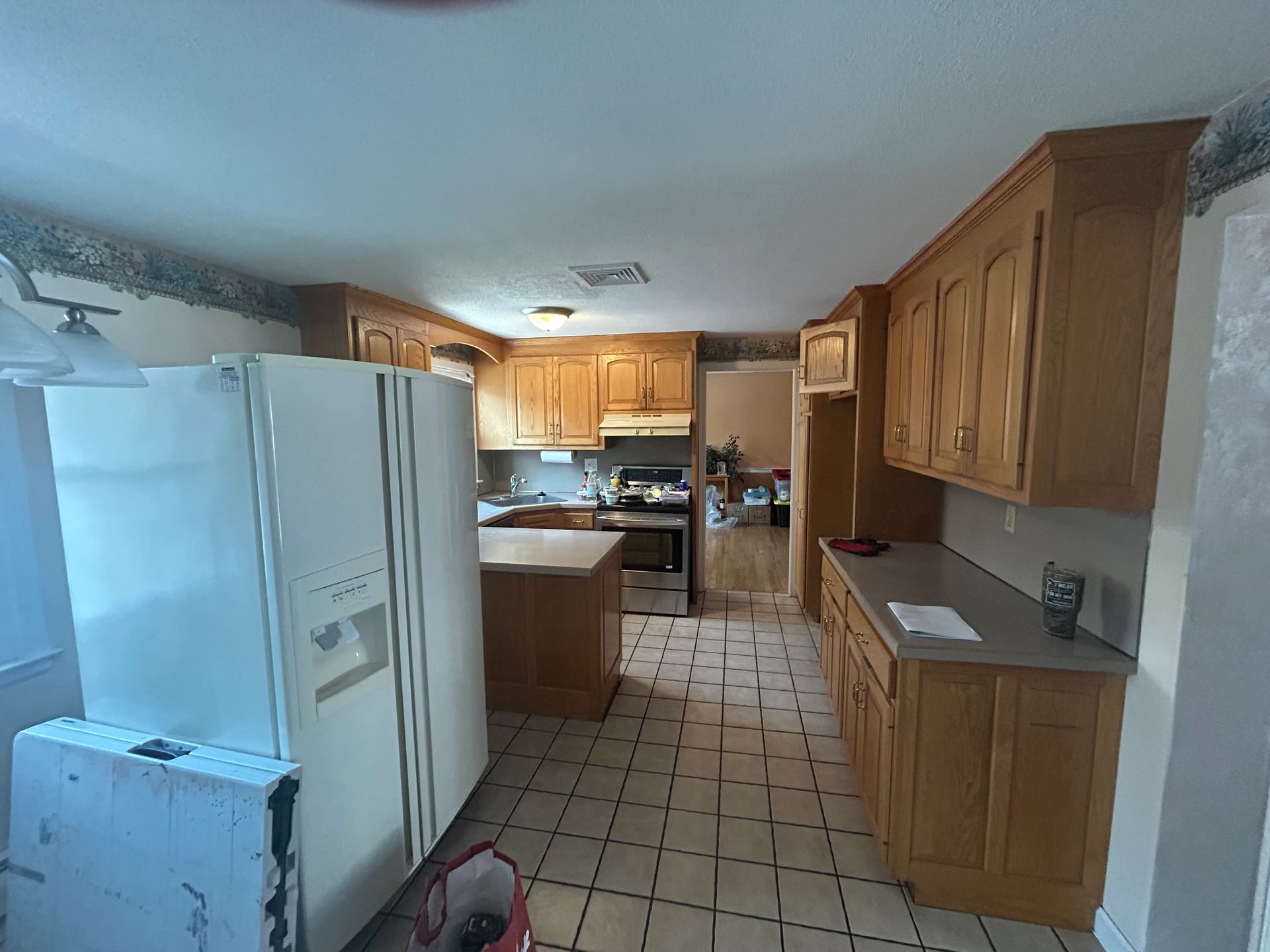 A kitchen with wooden cabinets and a white refrigerator