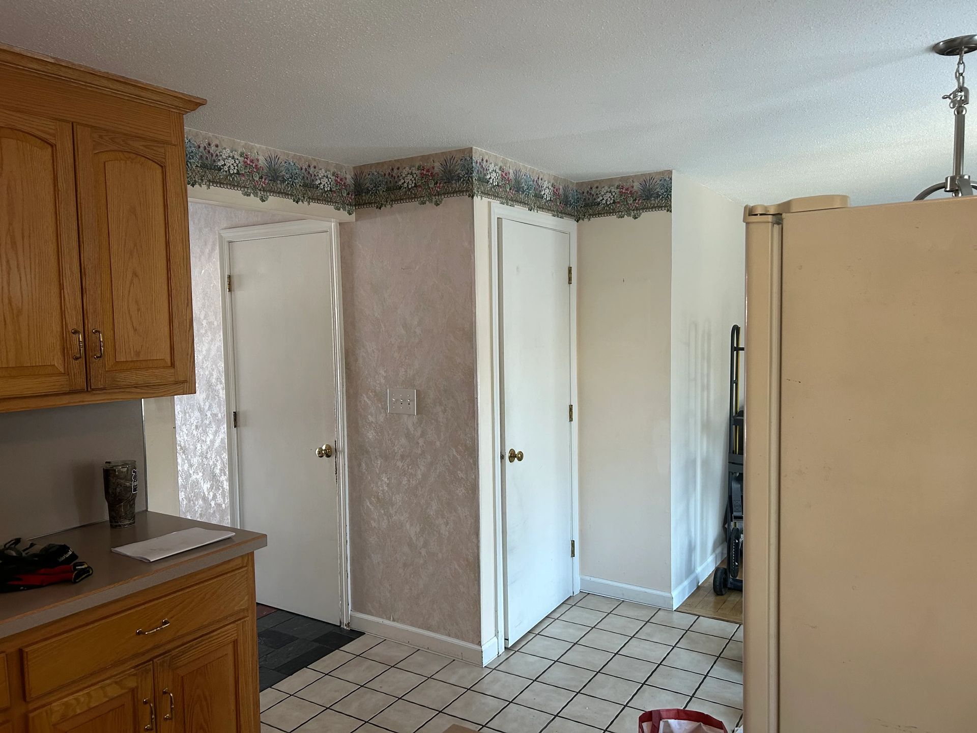 A kitchen with wooden cabinets and a white refrigerator.