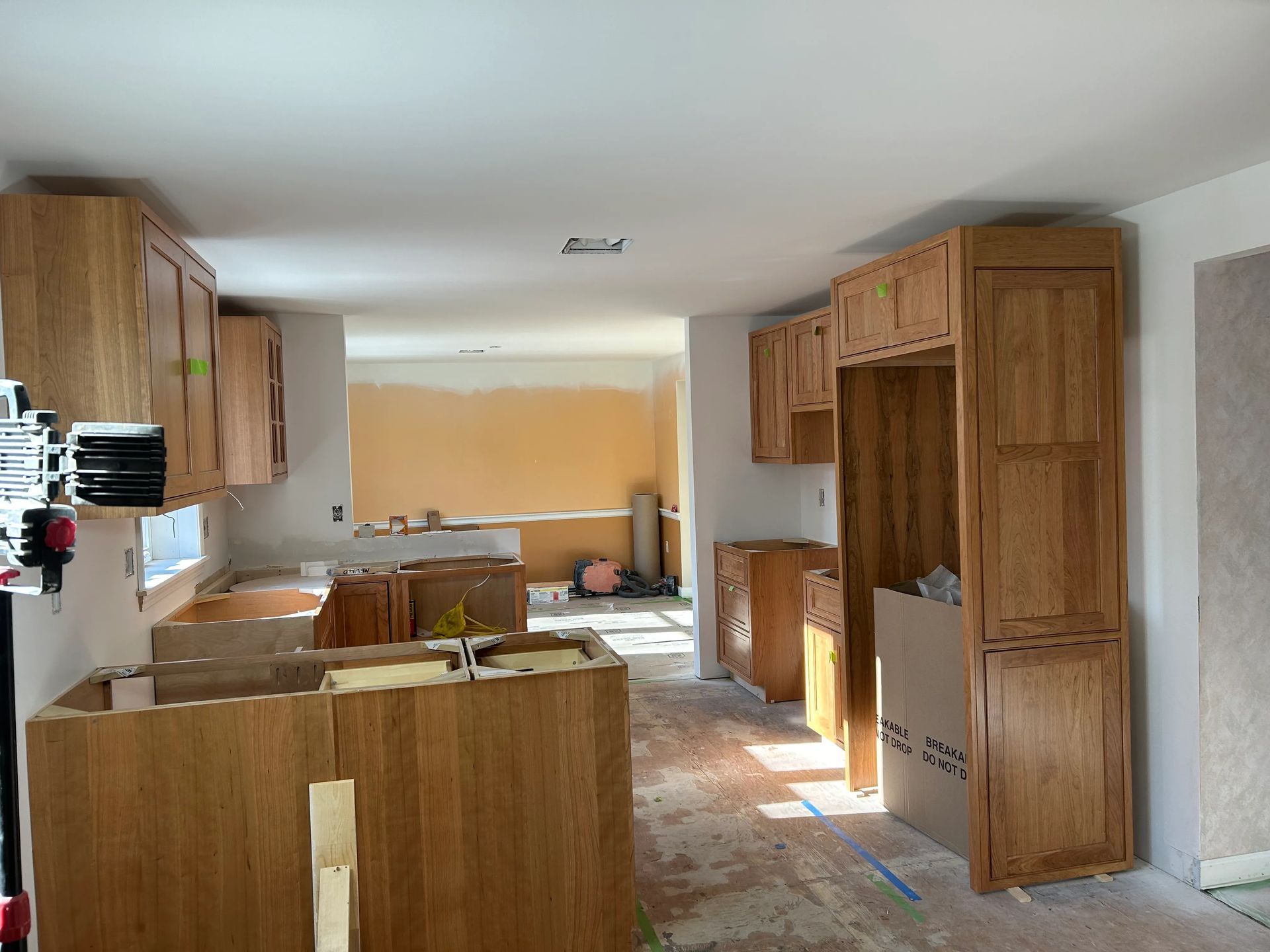 A kitchen under construction with wooden cabinets and a sink