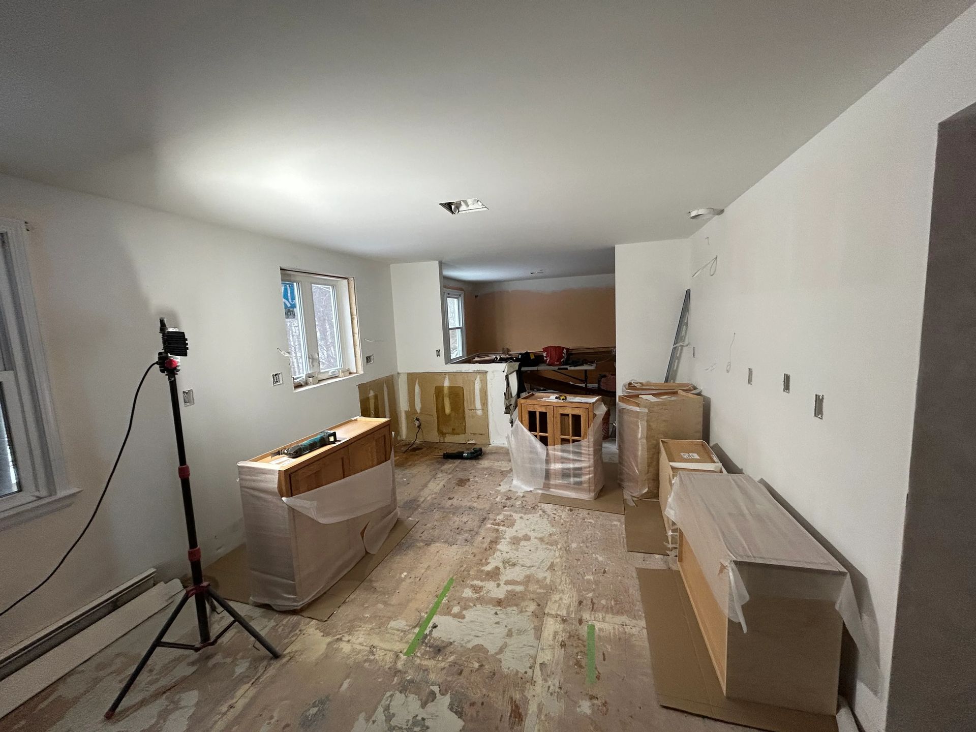 A room that is being remodeled with boxes on the floor.