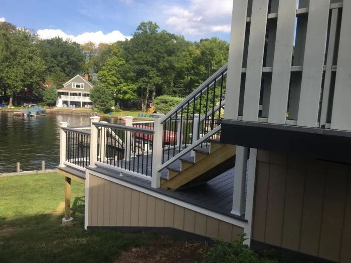 A deck with stairs leading up to a lake