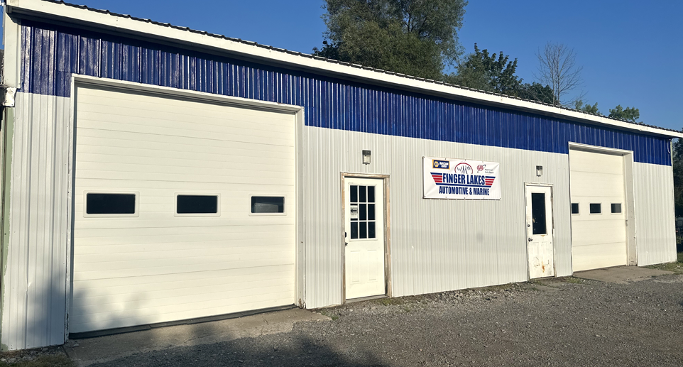 Red truck parked outside of garage | Finger Lakes Automotive & Marine