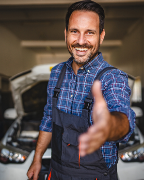 Mechanic installing rim of new wheel | Finger Lakes Automotive & Marine