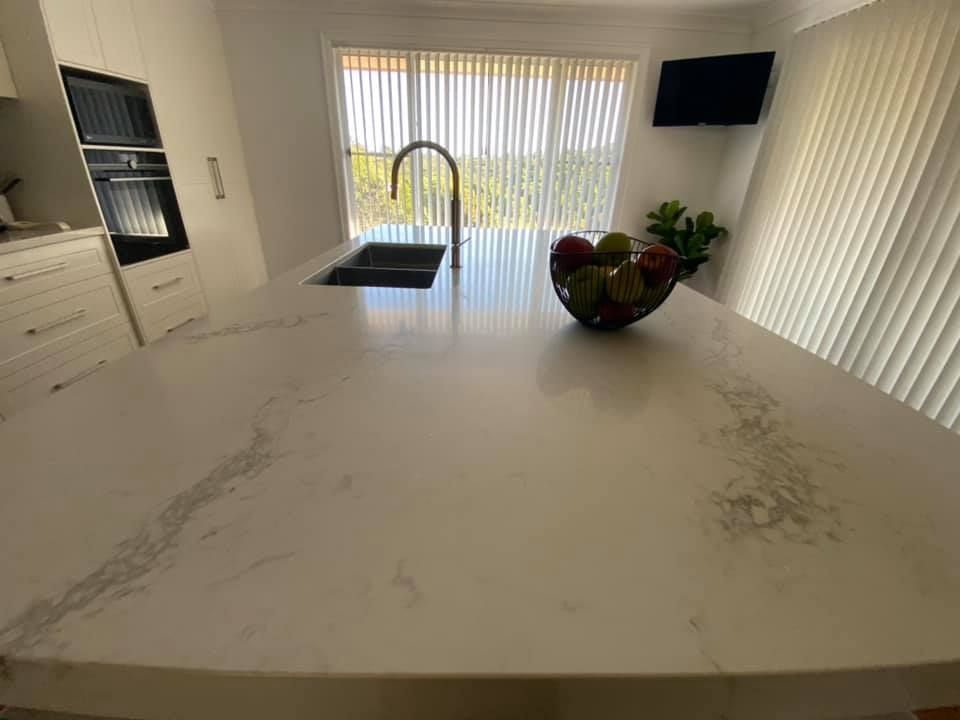 Marble White Countertop With Sink And Fruit Bowl — Kitchen Cabinets in Brunswick Heads, NSW