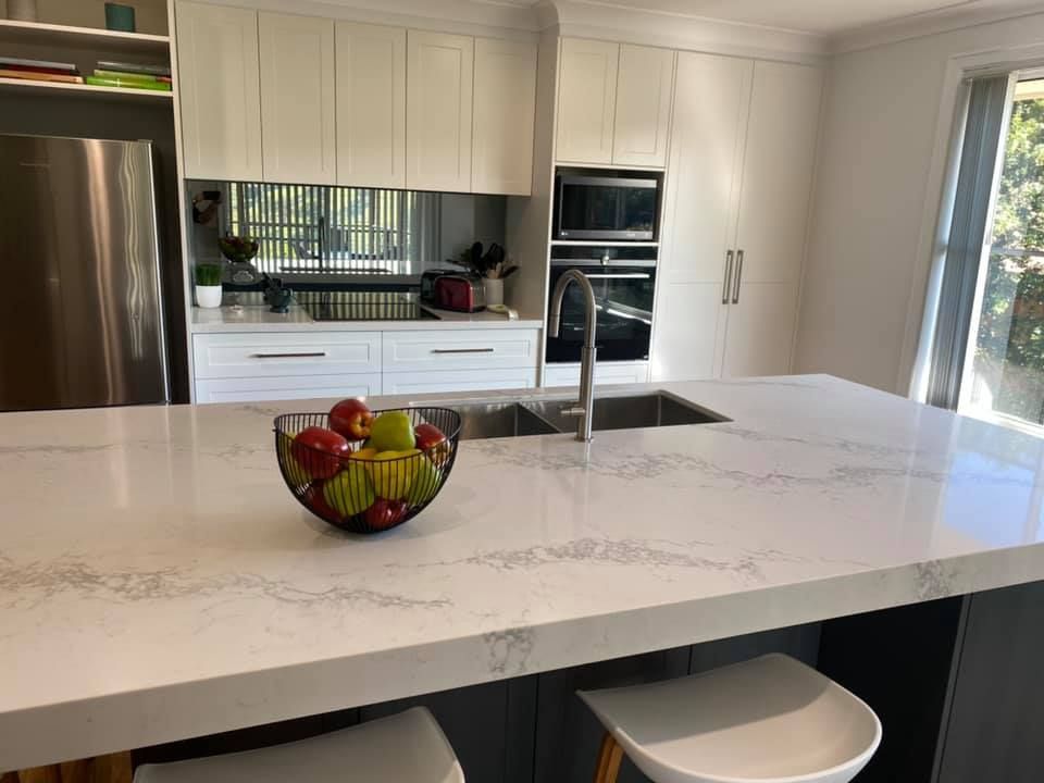 Kitchen With White Cabinets And White Marble Countertop — Kitchen Cabinets in Lismore, NSW