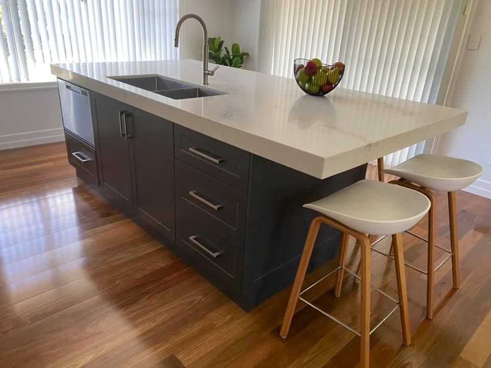 Kitchen Island With Grey Cabinets And Stool Bar Chairs — Kitchen Cabinets in Alstonville, NSW