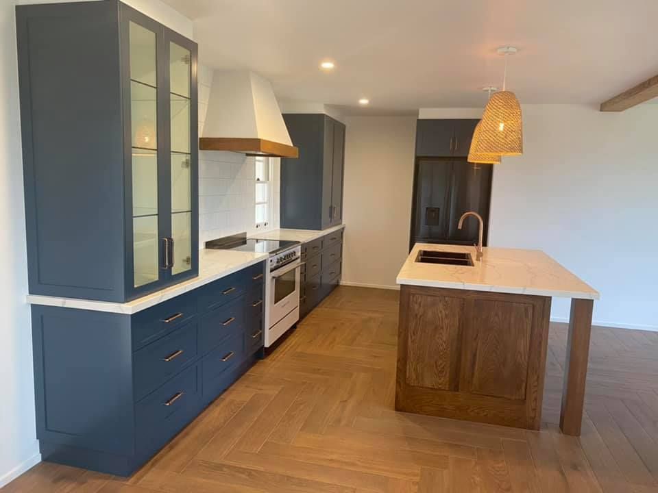 Kitchen With Blue Cabinets And Rattan Pendant Lights — Kitchen Cabinets in Alstonville, NSW