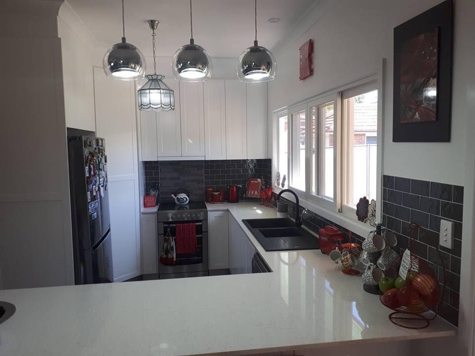 Elegant Kitchen With White Cabinets And Black Tiles — Kitchen Builders in Goonellabah, NSW