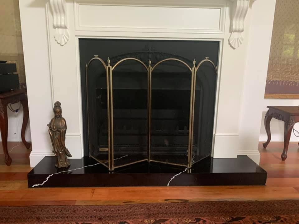 Fireplace And A Statue — Kitchen Cabinets in Northern Rivers, NSW
