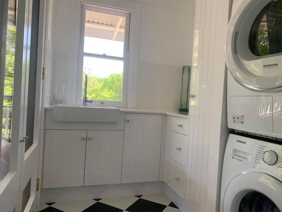 Laundry Room With White Cabinets And Sink — Custom Kitchens in Goonellabah, NSW