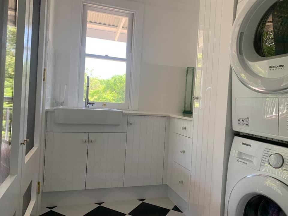 Laundry Room With Sink And White Cabinets — Kitchen Cabinets in Alstonville, NSW