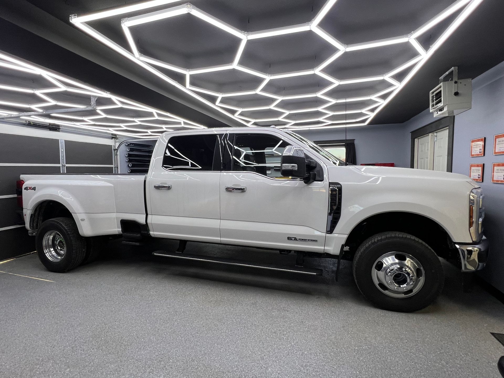 A gray sports car is parked in a garage.