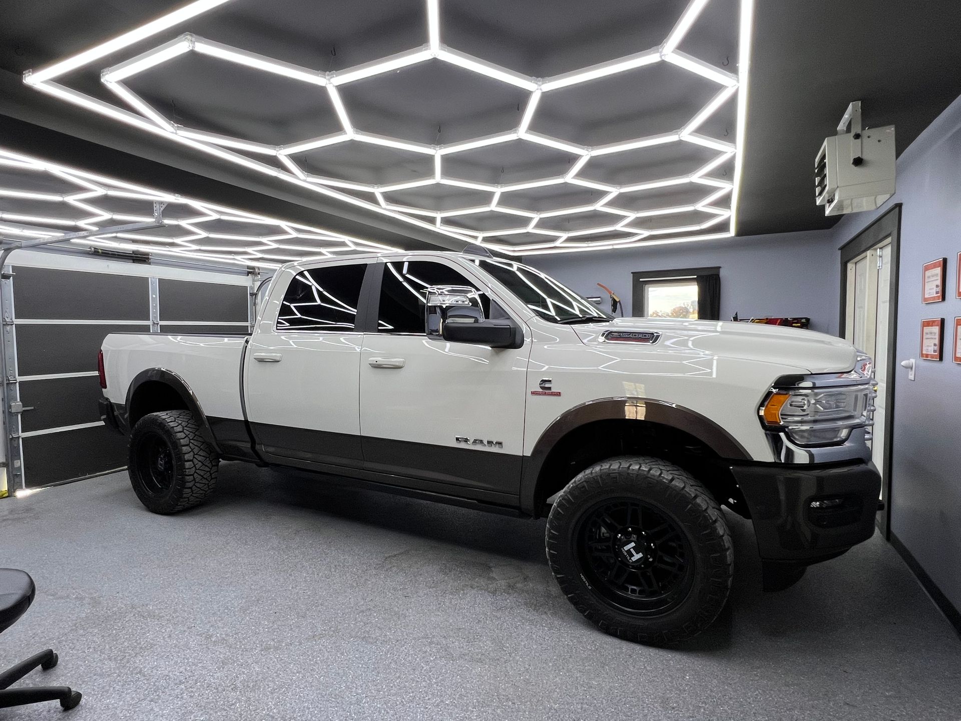 A silver sports car is parked in a garage.